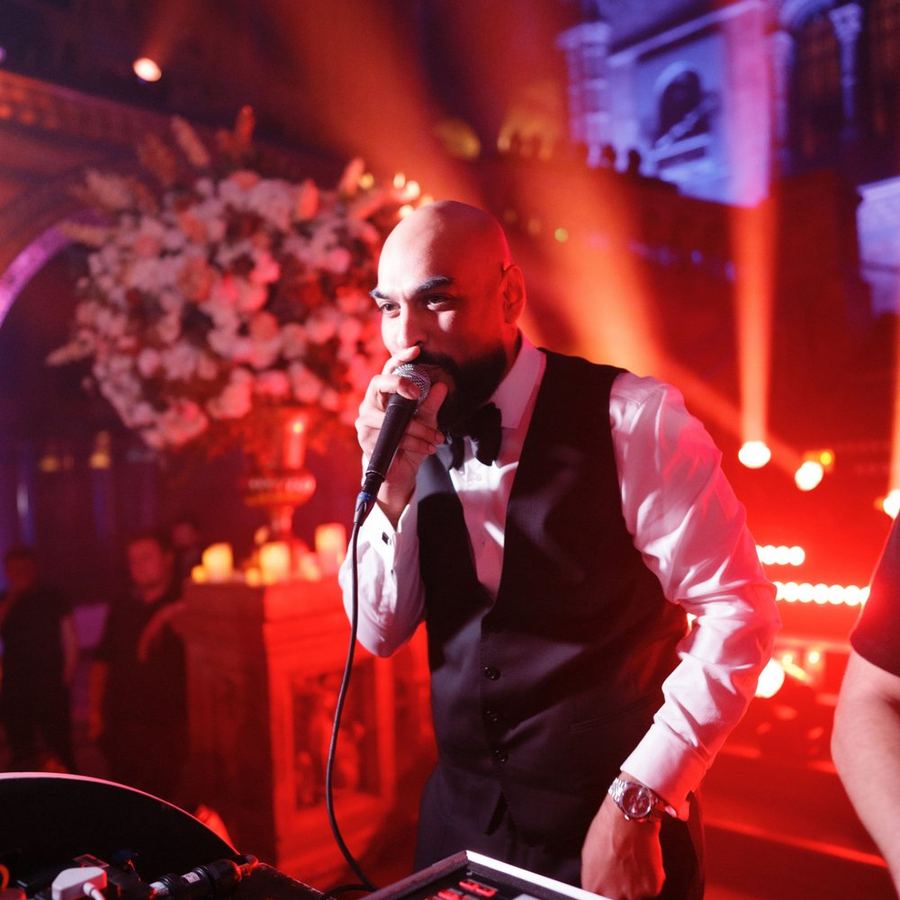 DJ Chonkx hosting and performing on the mic at a wedding reception