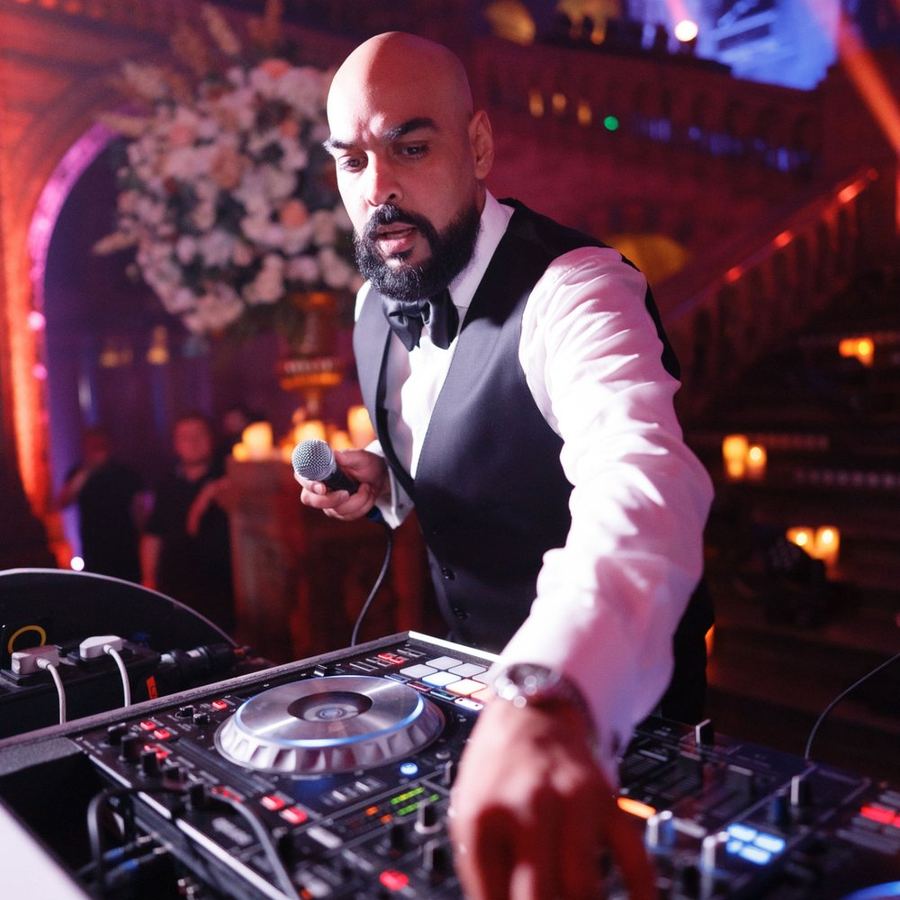 DJ Chonkx on the mic hosting a wedding event